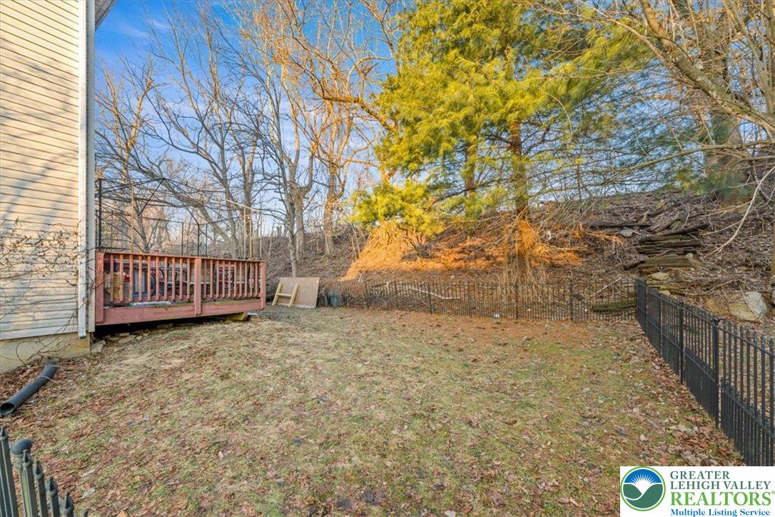 1409 Ravena Street Bethlehem, PA 18015 - Photo 34 of 40 a view of a yard with wooden fence and trees