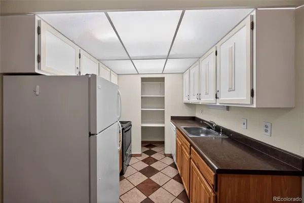a kitchen with stainless steel appliances a refrigerator a sink and cabinets