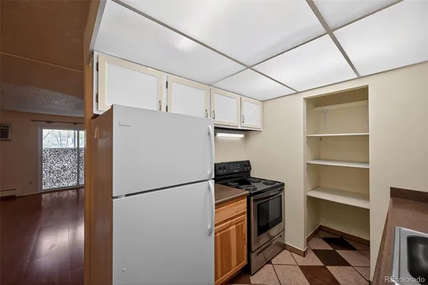 a kitchen with a refrigerator a stove and a window
