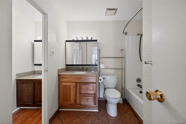 a bathroom with a toilet sink and shower