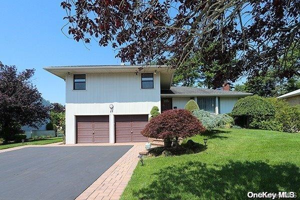 23 Maytime Drive Jericho, NY 11753 - Photo 1 of 1 front view of a house with a yard