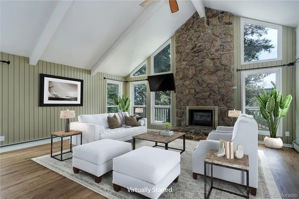 a living room with furniture a fireplace and a potted plant