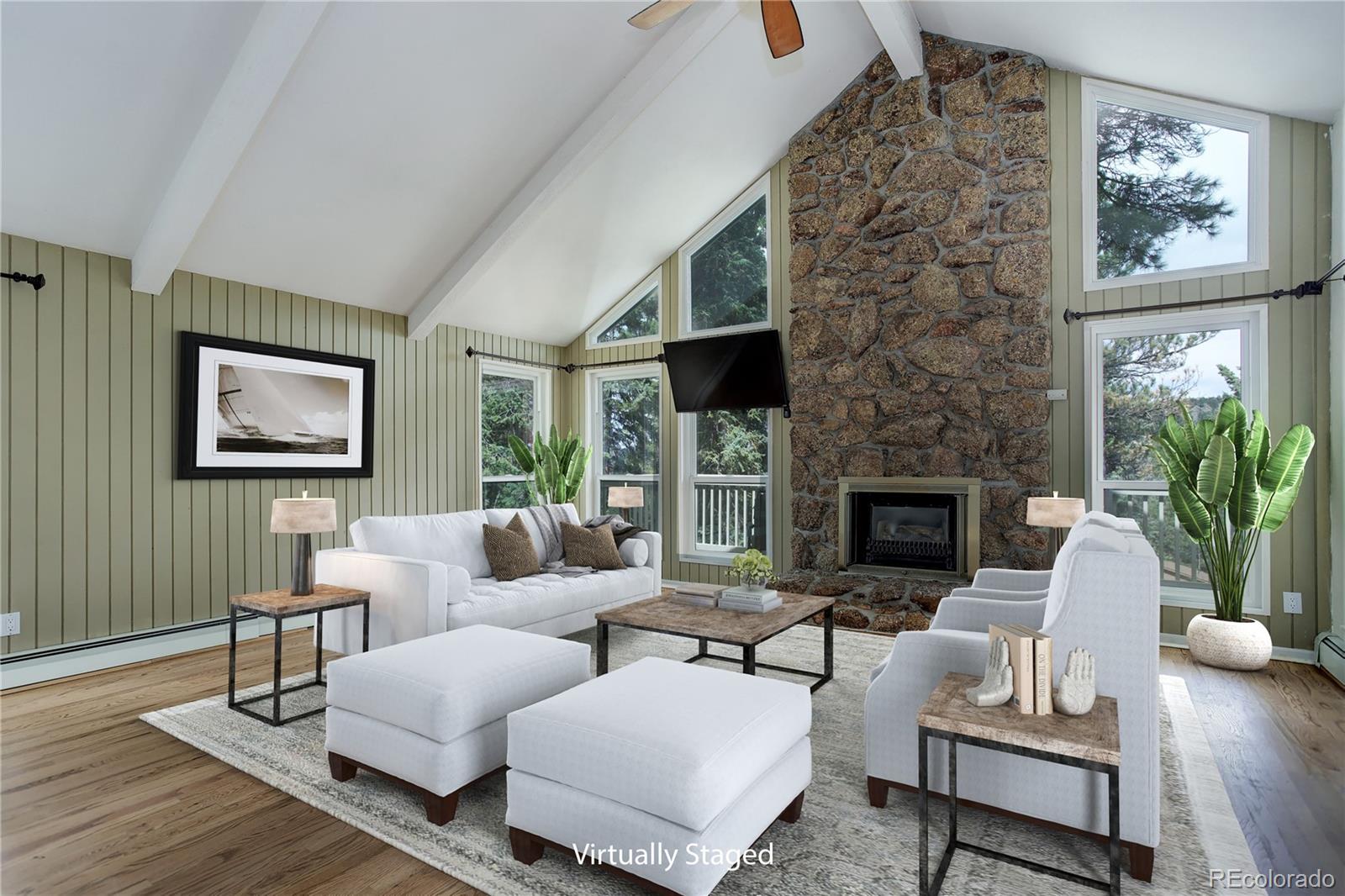 a living room with furniture a fireplace and a potted plant