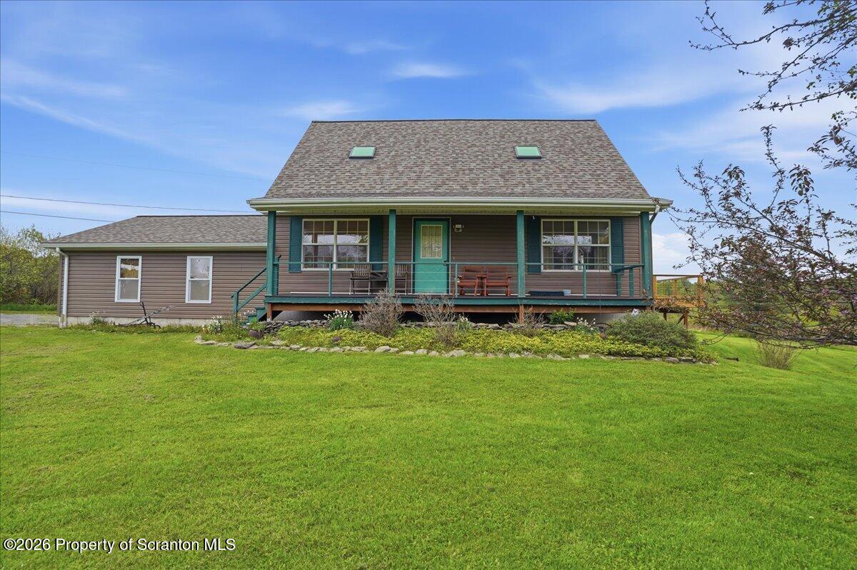 5231 Fiddle Lake Road Thompson, PA 18465 - Photo 3 of 34 a front view of a house with a garden