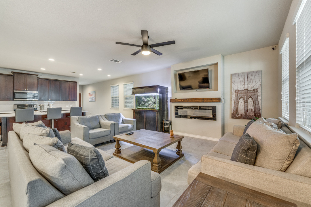 5921 Lehman Way Austin, TX 78747 - Photo 4 of 25 An inviting open-concept living space features a cozy fireplace and seamless flow into the kitchen.