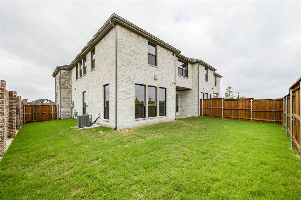 3420 Brocco Road Celina, TX 75009 - Photo 27 of 27 Expansive green lawn with a white brick exterior and dark-framed windows