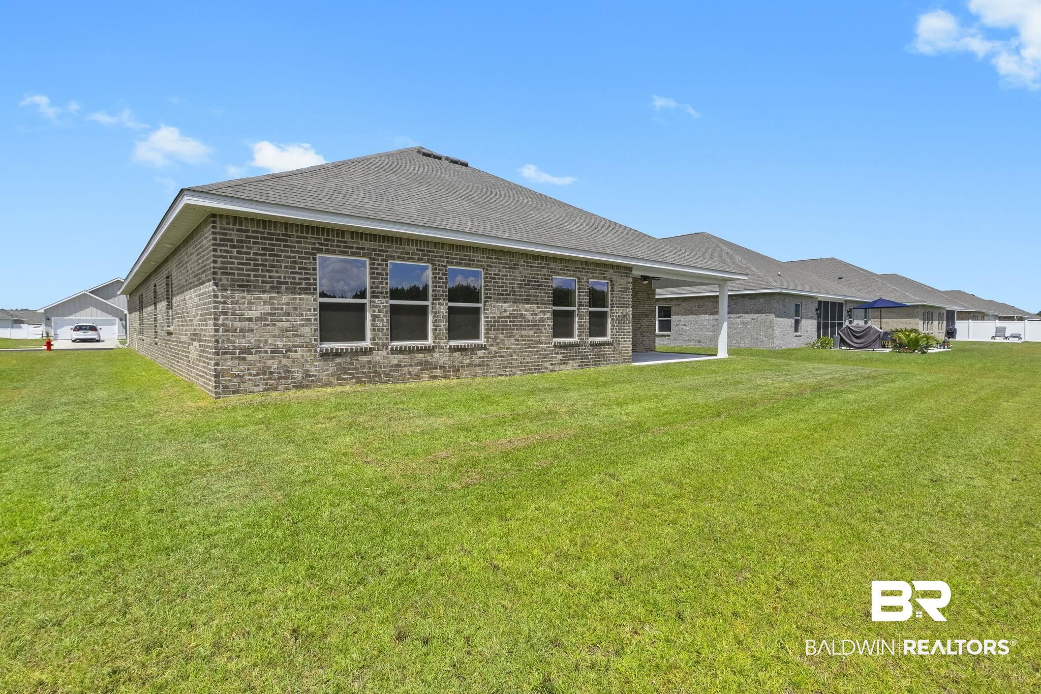 11303 Genuine Risk Circle Daphne, AL 36526 - Photo 71 of 100 Rear view of property featuring a patio area and a yard