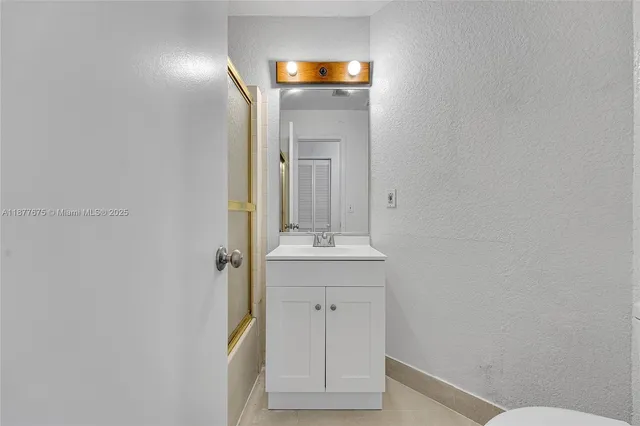 a bathroom with a sink a mirror and a toilet