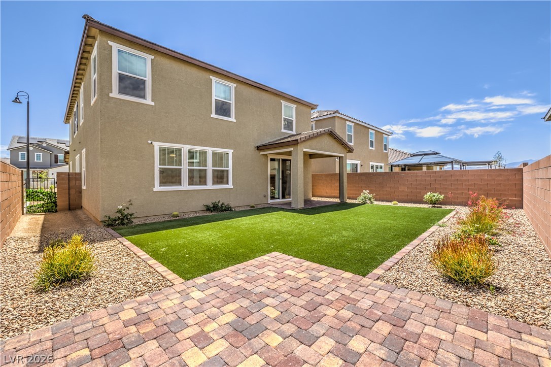 3782 Alla Rocca Avenue Henderson, NV 89044 - Photo 41 of 55 The backyard features a paver patio and artificial turf, perfect for outdoor living.