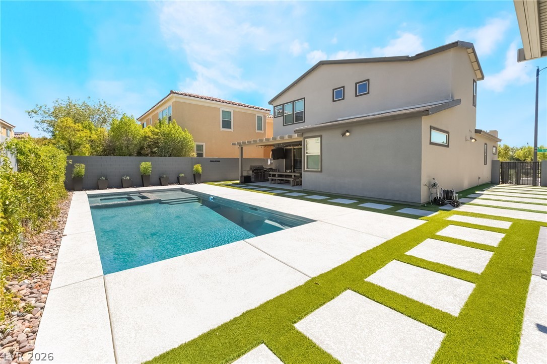 2166 Trivero Street Henderson, NV 89044 - Photo 44 of 61 A modern outdoor living space featuring an inviting pool and a stylish patio.