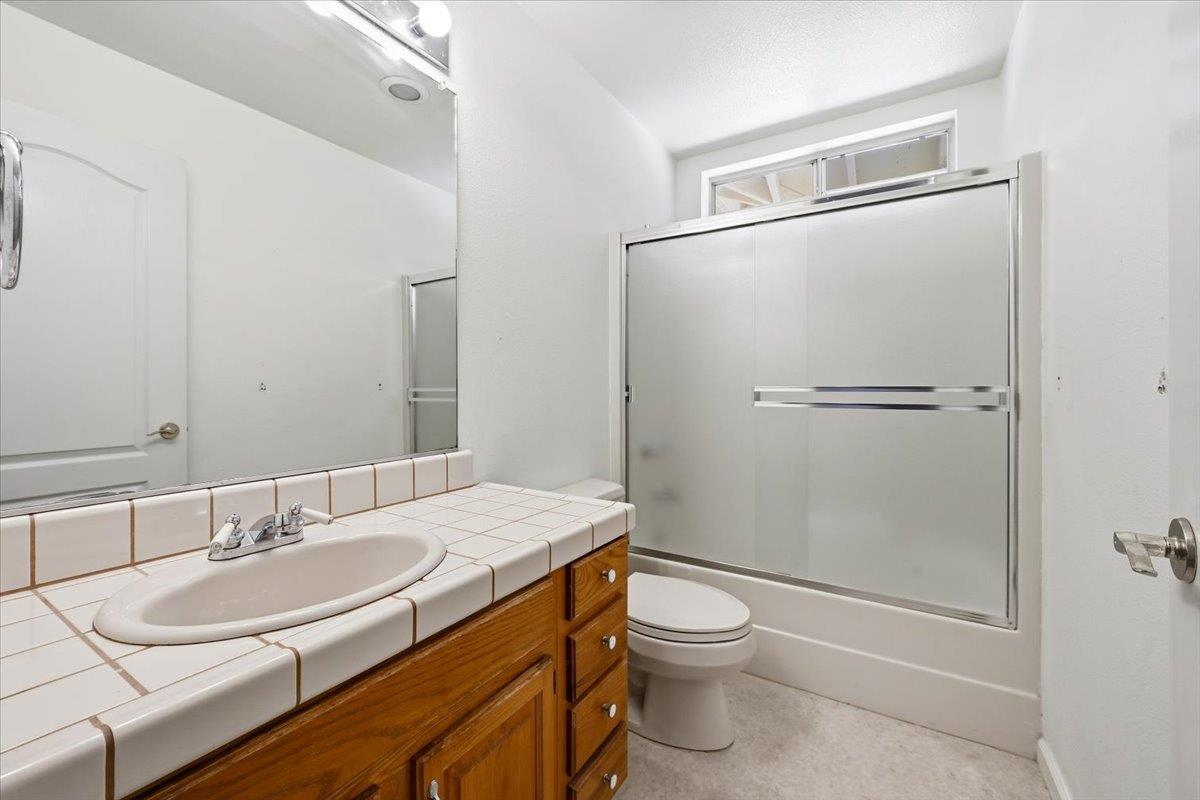 12600 Friar Tuck Road Grass Valley, CA 95949 - Photo 15 of 56 a bathroom with a granite countertop sink toilet and shower