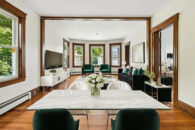 a view of a dining room with furniture window and wooden floor