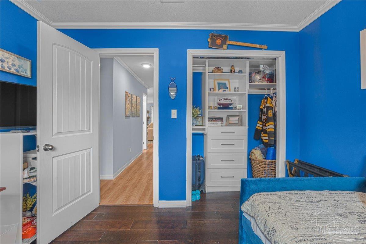 4831 East Olive Road, Unit 1D Pensacola, FL 32514 - Photo 23 of 36 a view of a hallway with wooden floor and staircase