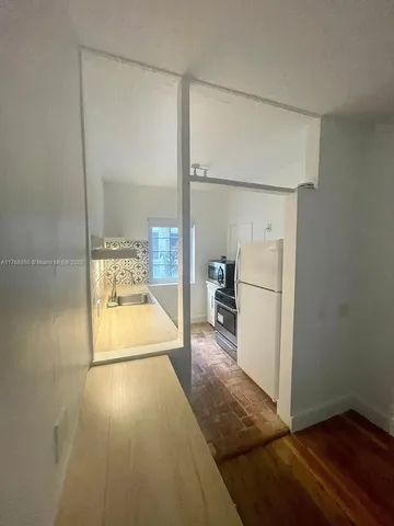 a bathroom with a tub shower and sink