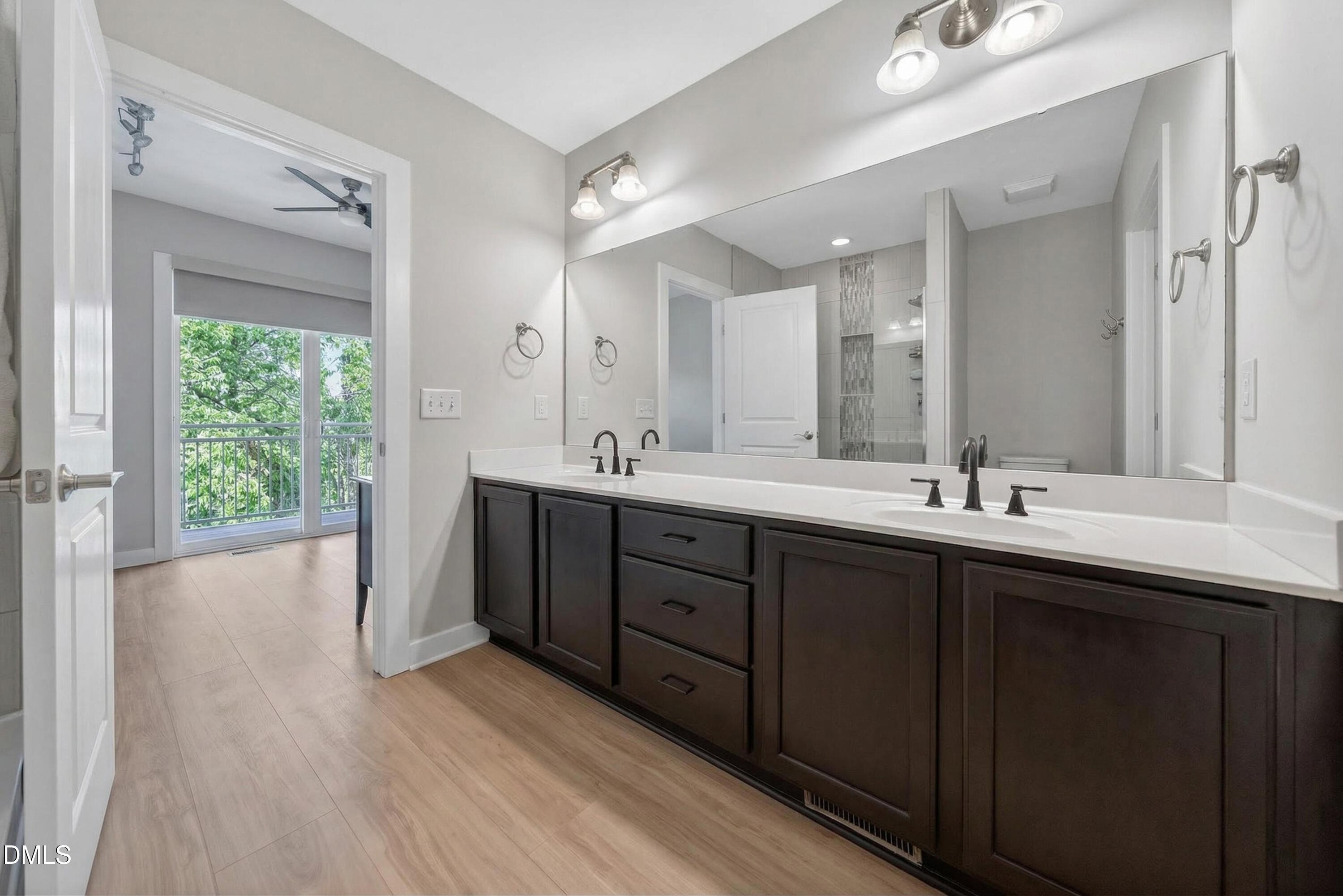 444 South Blount Street, Unit 111 Raleigh, NC 27601 - Photo 17 of 40 a spacious bathroom with a double vanity sink a large mirror and shower