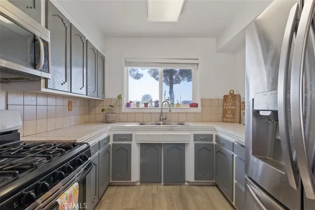 a kitchen with a sink stove and refrigerator
