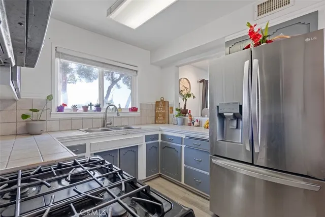 a kitchen with stainless steel appliances a stove a microwave and cabinets