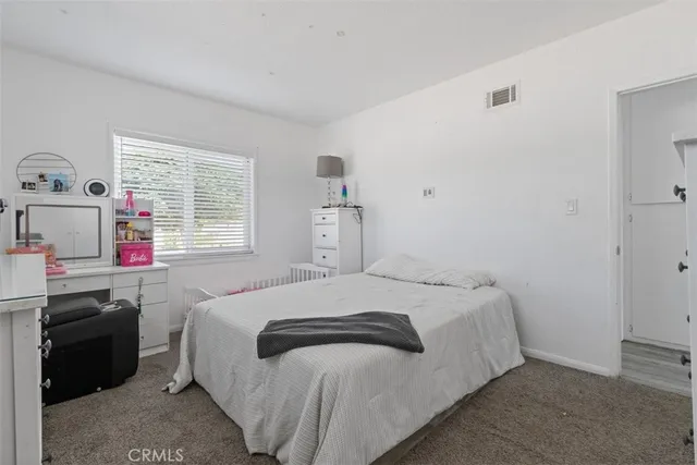 a bedroom with a bed and a dresser