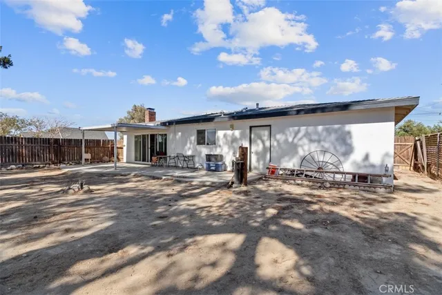 a front view of a house with a yard and potted plants