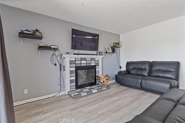 a living room with furniture a flat screen tv and a fireplace
