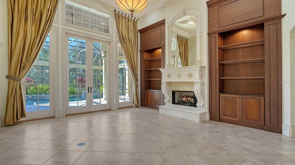 3218 Signet Court Sarasota, FL 34240 - Photo 13 of 82 a view of an empty room with a fireplace and a window