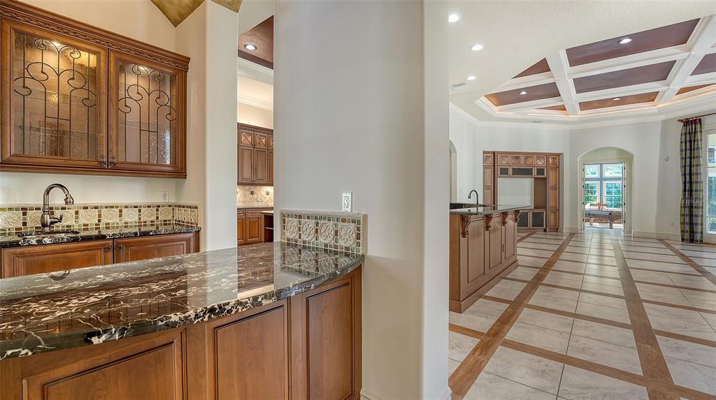 3218 Signet Court Sarasota, FL 34240 - Photo 17 of 82 a kitchen with granite countertop a sink and cabinets