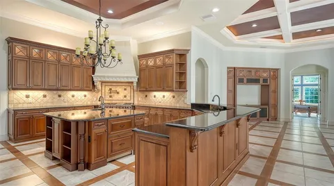 a kitchen with stainless steel appliances granite countertop a refrigerator and a stove