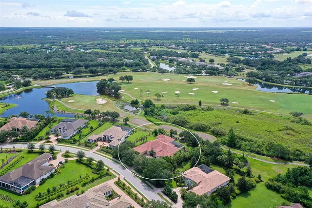 an aerial view of residential houses with outdoor space and river
