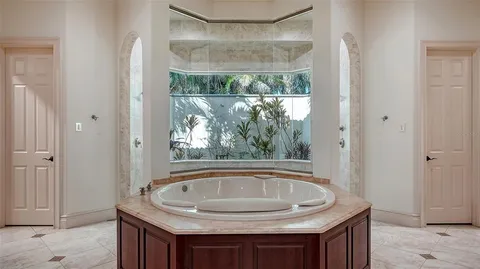 an aerial view of residential houses with outdoor space and trees