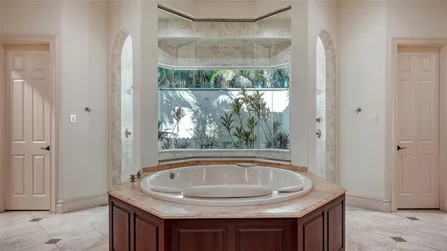 an aerial view of residential houses with outdoor space and trees