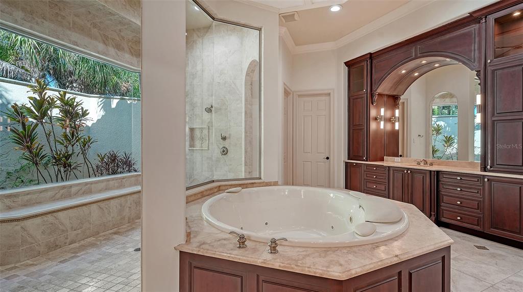 3218 Signet Court Sarasota, FL 34240 - Photo 40 of 82 a bathroom with a granite countertop sink a mirror and shower