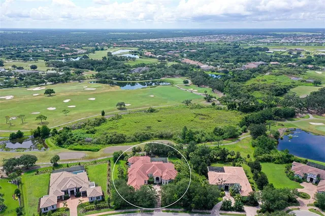 an aerial view of residential houses with outdoor space and river