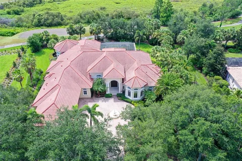 an aerial view of a house with garden space and street view