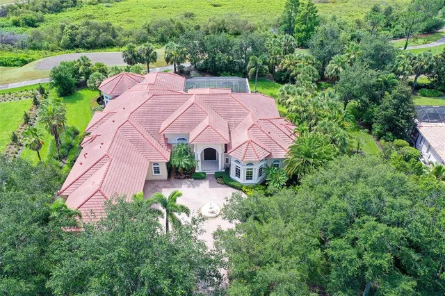 an aerial view of a house with garden space and street view