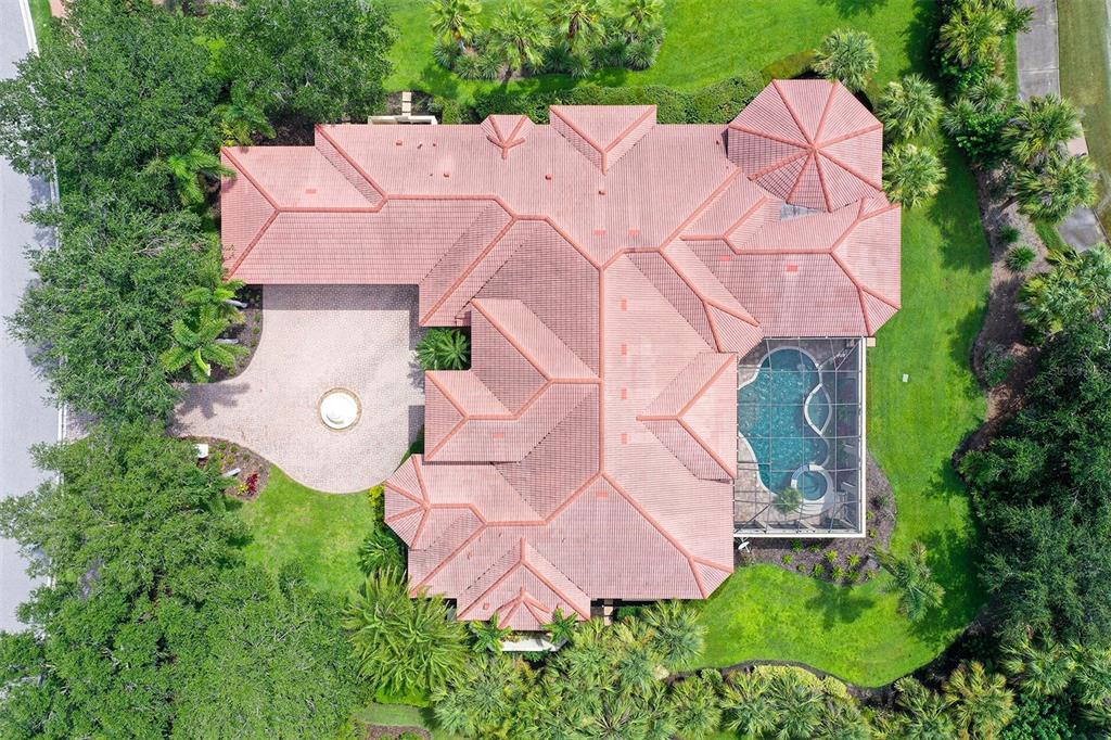 3218 Signet Court Sarasota, FL 34240 - Photo 61 of 82 an aerial view of a house with table and chairs under an umbrella