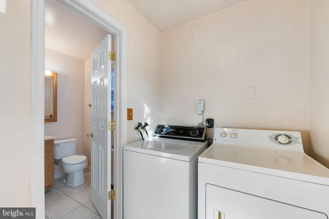 a view of bathroom with a toilet sink and mirror
