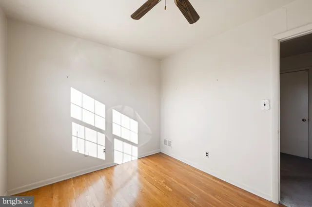 an empty room with windows and view fan