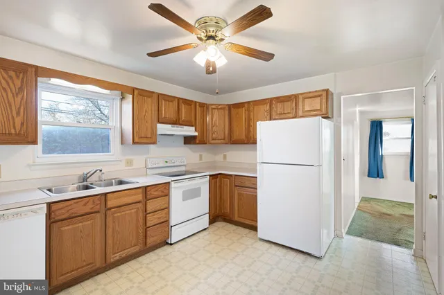 a kitchen with a refrigerator a sink and cabinets