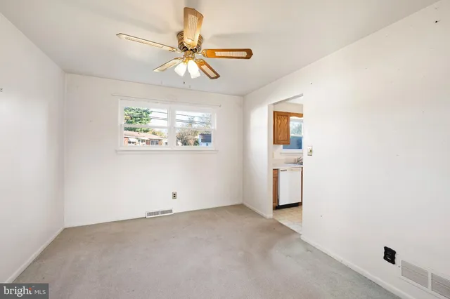 a view of a livingroom with a ceiling fan and window