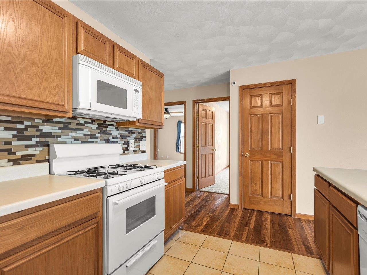 10184 Metalmark Lane Roscoe, IL 61073 - Photo 15 of 29 a kitchen with a stove a sink and a refrigerator