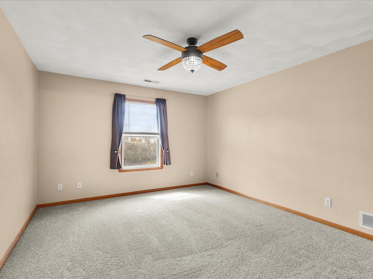 10184 Metalmark Lane Roscoe, IL 61073 - Photo 19 of 29 an empty room with windows and fan