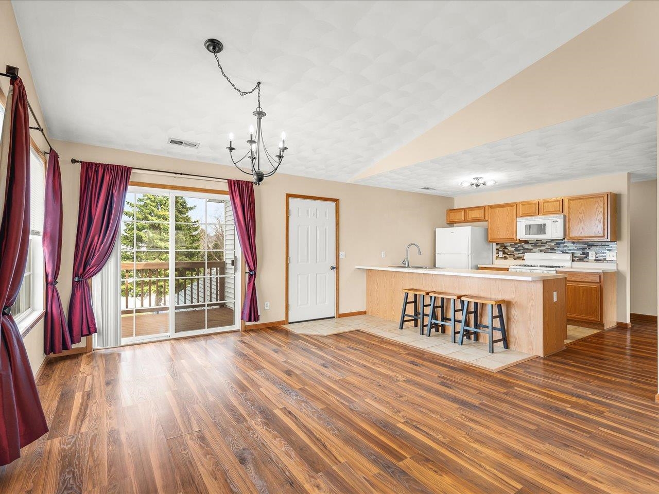 10184 Metalmark Lane Roscoe, IL 61073 - Photo 6 of 29 a view of an empty room with wooden floor and a window