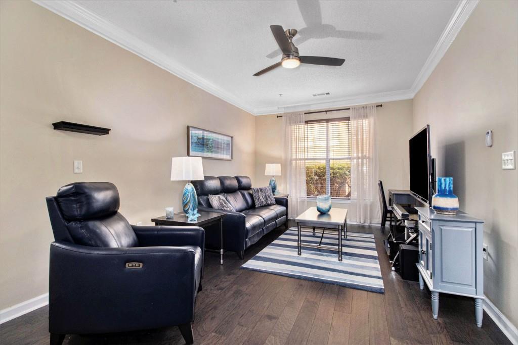 10 Perimeter Summit Boulevard, Unit 2112 Atlanta, GA 30319 - Photo 12 of 40 a living room with furniture and a flat screen tv