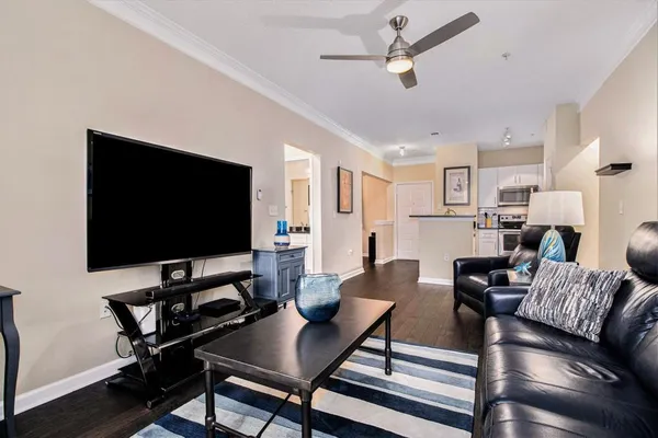 a living room with furniture and a flat screen tv