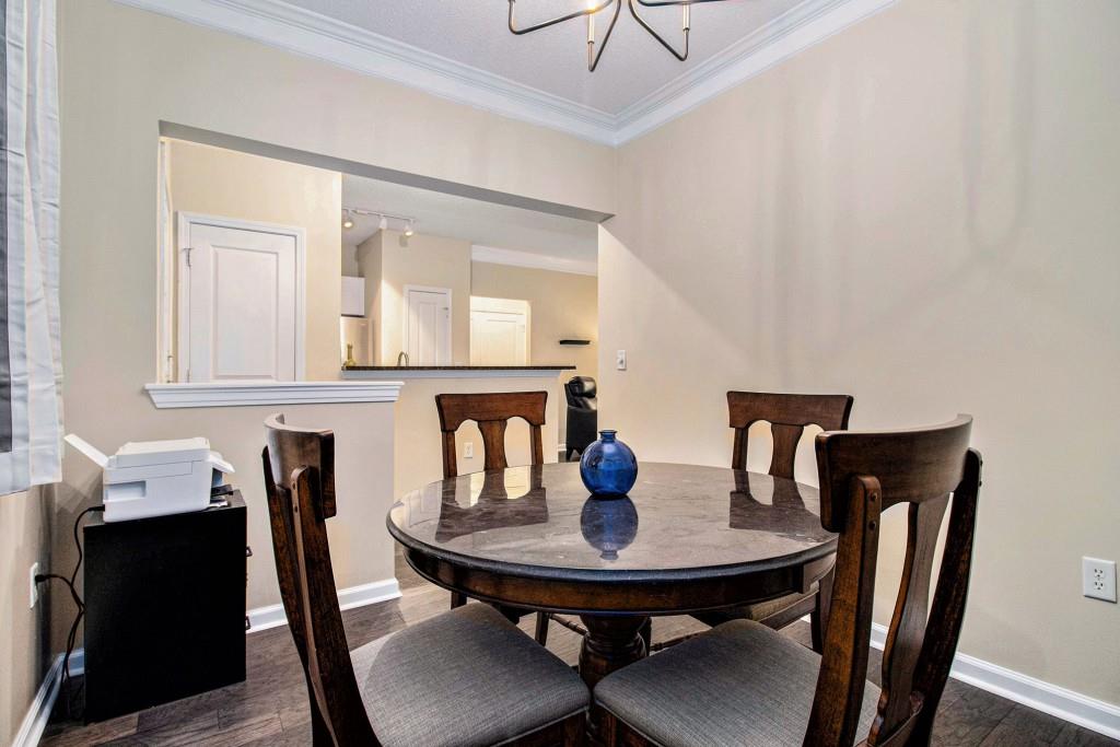 10 Perimeter Summit Boulevard, Unit 2112 Atlanta, GA 30319 - Photo 16 of 40 a view of a dining room with furniture and wooden floor