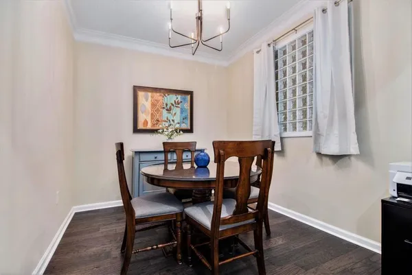 a view of a dining room with furniture and a window