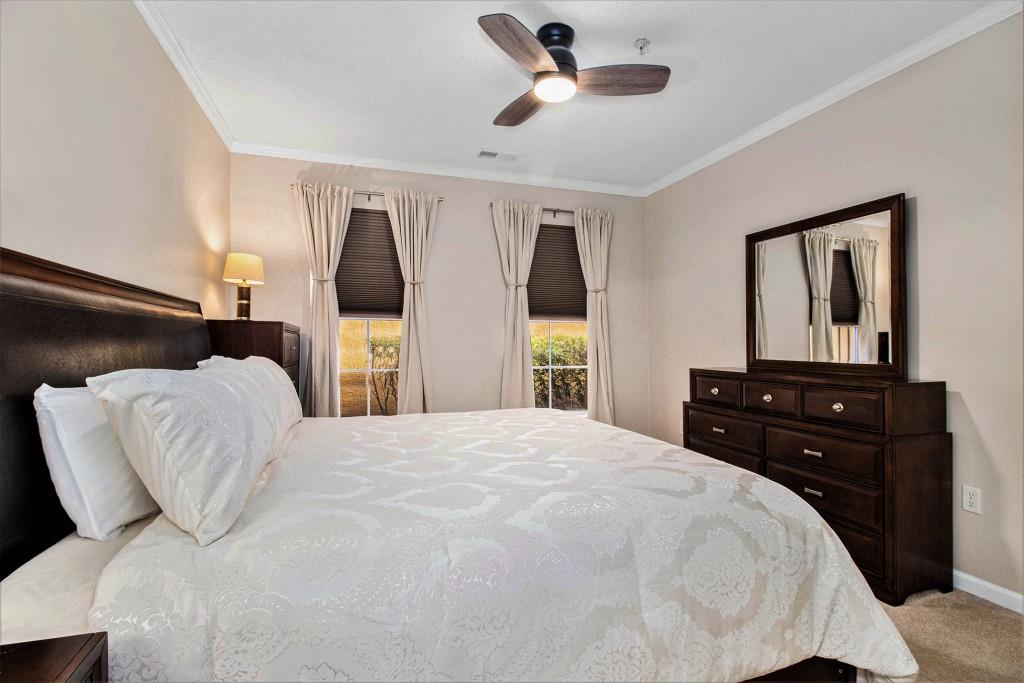 10 Perimeter Summit Boulevard, Unit 2112 Atlanta, GA 30319 - Photo 18 of 40 a bedroom with a bed and a dresser
