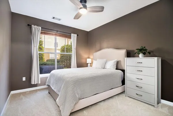 a bedroom with a large bed and a window