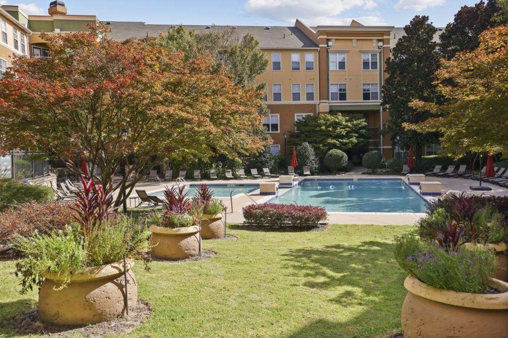 10 Perimeter Summit Boulevard, Unit 2112 Atlanta, GA 30319 - Photo 27 of 40 a swimming pool with outdoor seating and yard
