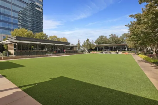 a view of swimming pool with outdoor seating and city view